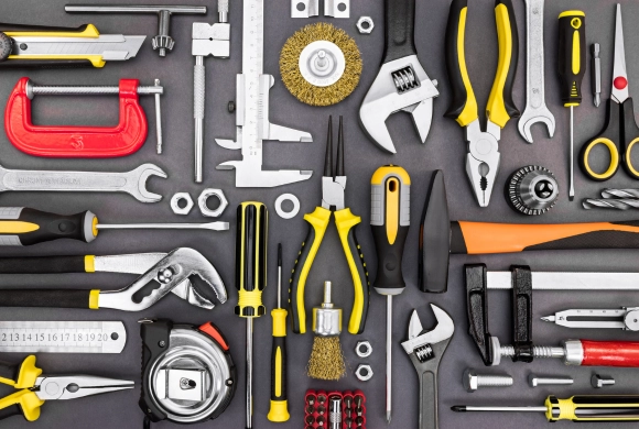 A photograph of a collection of tools spread out across a table.